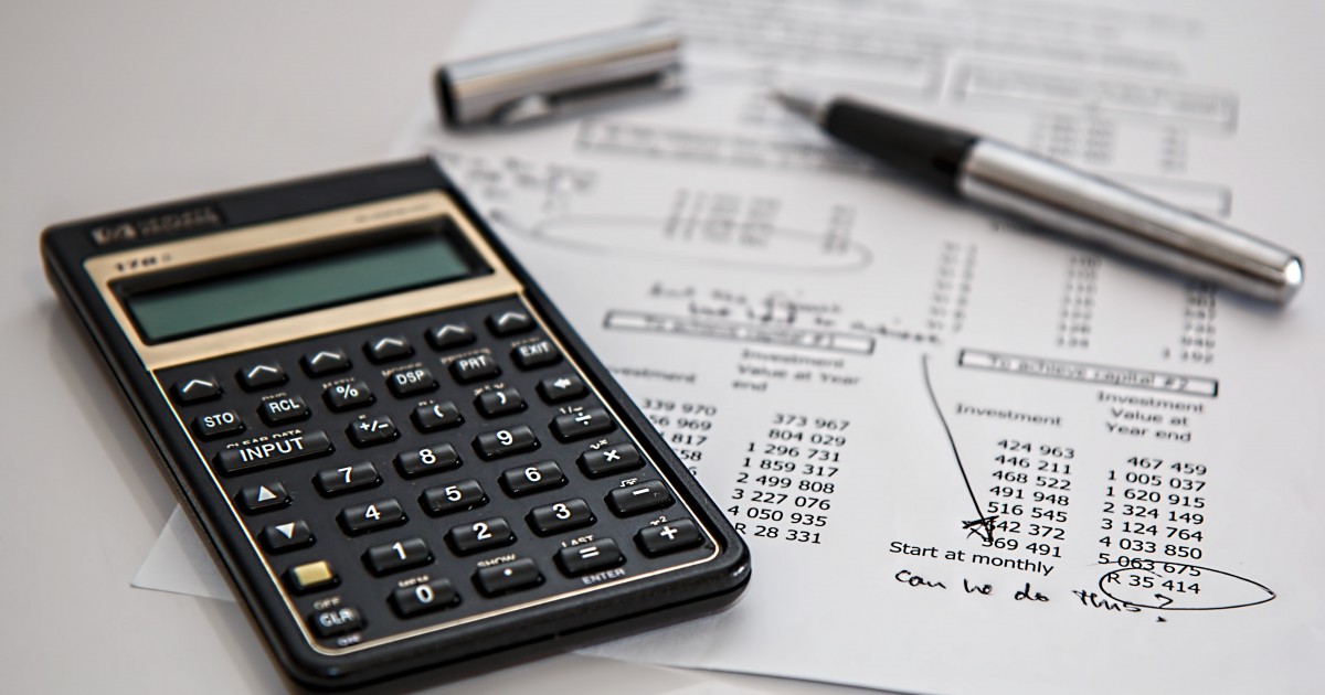 Calculator and financial document with handwritten notes